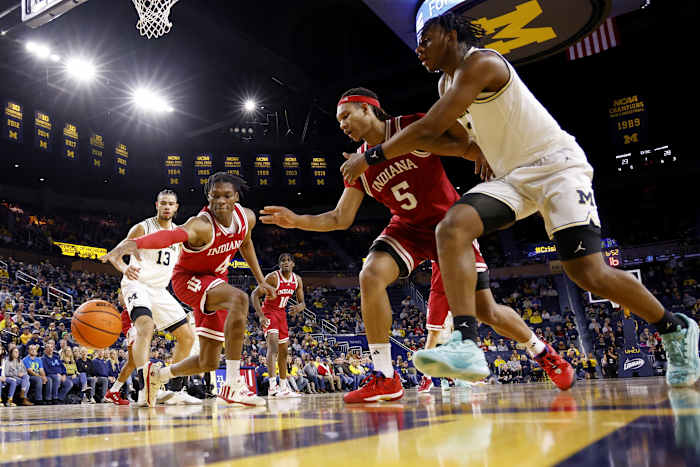 Hoosiers forward Anthony Walker (4) and Hoosiers forward Malik Reneau (5) go for the ball against the Michigan Wolverines.